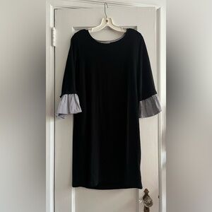 Black jersey dress w long sleeves and striped cotton blousing at wrist.